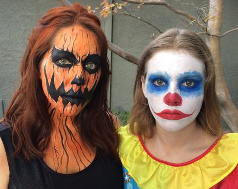 Two people posing with Halloween face paint